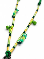 Close-up of kiwi slice and avocado beads on the green and gold wrapped cord of the Amalfi phone strap