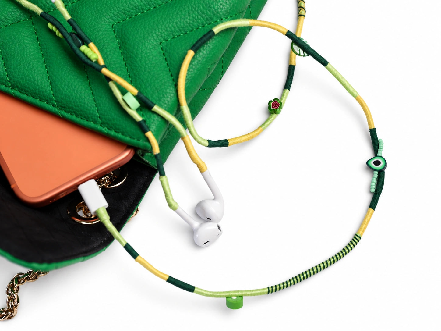 Botanica Beaded USB-C EarPods — handmade Apple USB-C earphones in lime, forest green and yellow with kiwi, leaf and evil-eye beads, styled with a green quilted bag