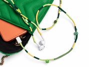 Botanica Beaded USB-C EarPods — handmade Apple USB-C earphones in lime, forest green and yellow with kiwi, leaf and evil-eye beads, styled with a green quilted bag