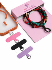 Marrakech phone strap in its open gift box with phone case and phone patch in pink, black and purple
