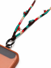 Close-up of spotted red mushroom and turquoise seed beads on the Marrakech phone strap
